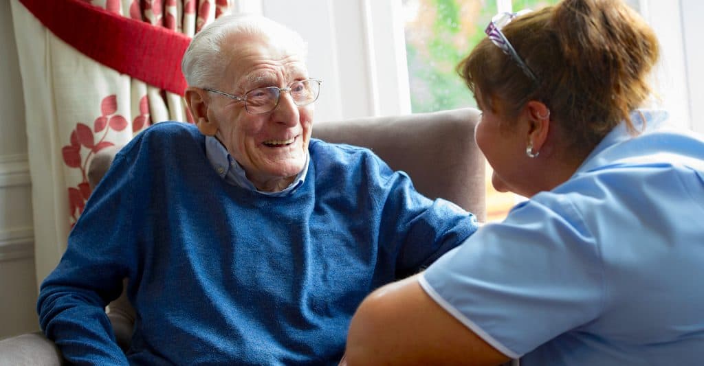 male resident talking with carer