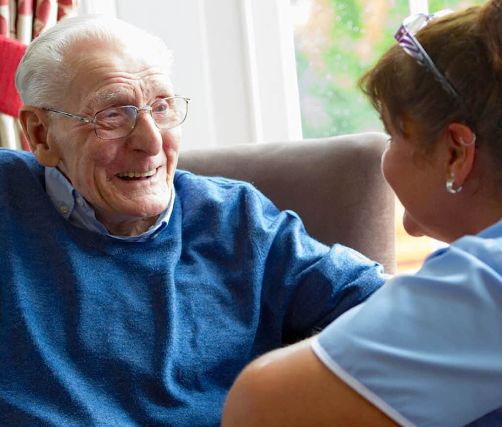 Elderly resident at care home with nurse